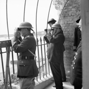Winston Churchill viewing activity in the Channel from an observation post at Dover Castle during his tour of defences, 28 August 1940. Enemy air attacks were in progress at the time, and two German bombers were seen to crash into the sea.